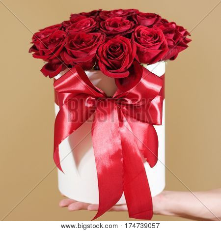 Man Hand Holding Rich Gift Bouquet Of 21 Red Roses. Composition Of Flowers In A White Hatbox. Tied W