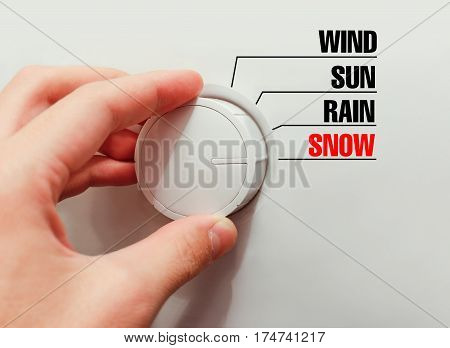 Male Hand Turns The Switch. Switches Weather. Chose The Snow.