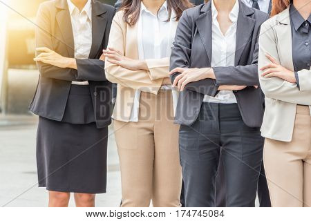 Success Teamwork Concept Business people standing with arms crossed city background.