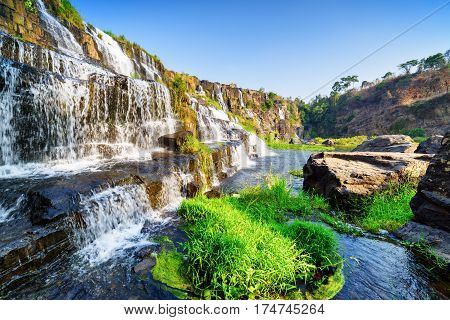 Side View Of Natural Cascading Waterfall With Clear Water