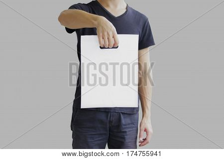 Man Shows Blank Plastic Bag Mock Up Isolated. Empty White Polyethylene Package Mockup. Consumer Pack