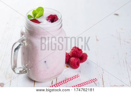 Raspberry jogurt smoothie in glass jar, copy space
