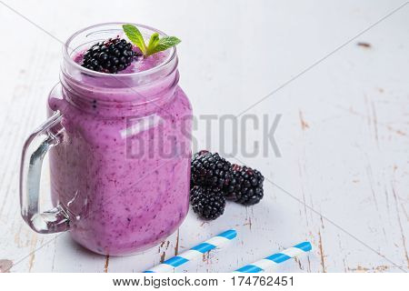 Blackberry jogurt smoothie in glass jar, copy space