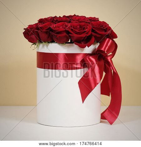 Rich Gift Bouquet Of 21 Red Roses. Composition Of Flowers In A White Hatbox. Tied With Wide Red Ribb