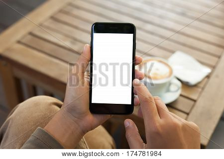 close-up hand holding phone mobile blank screen and finger touching in coffee shop