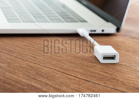 close-up cable data convert to laptop computer new modern technology transfer connect