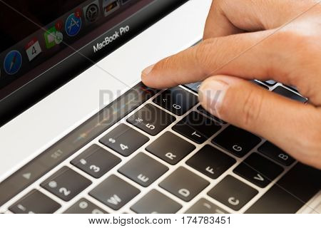 Bangkok Thailand - january 5 2017: Close-up hand touching touch bar on macbook pro 2016 mixing audio sound touch bar is new function on macbook pro 2016 by apple Inc.
