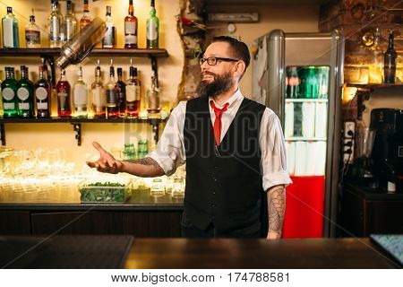 Bartender with shaker show professional trick