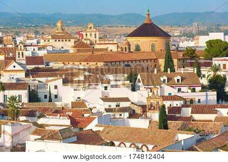 Roof of the old city and church Iglesia del Colegio de Santa Victoria, aerial view from the bell tower at the Mezquita in Cordoba, Andalusia, Spain