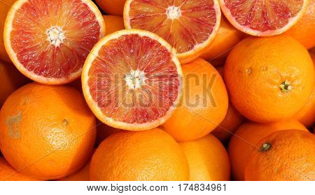 Ripe Oranges And An Orange Cut In The Stall Of Greengrocer