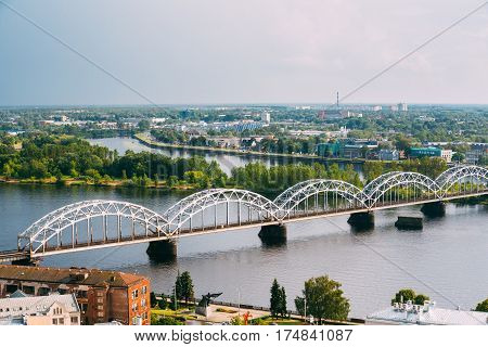 Riga, Latvia. Top View, Aerial View Of Railway Bridge Through Daugava Or Western Dvina River At Evening