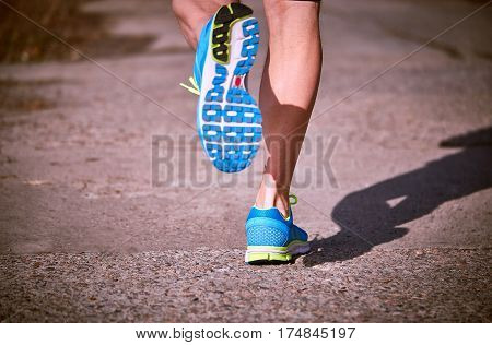 Foot closeup athlete running in sneakers outdoors.