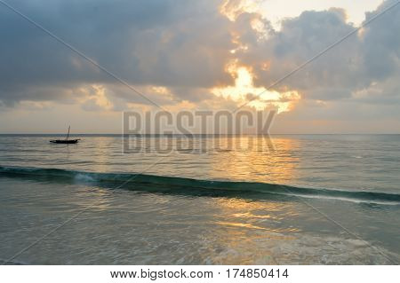 Dhow on the ocean at sunrise on Bamburi beach in Kenya