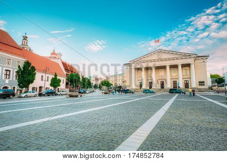 Vilnius, Lithuania. The View Of Main Facade Of Town Council, Administrative Building With Columns On Didzioji Street In Old Town In Summer Day Under Blue Sky With Clouds.