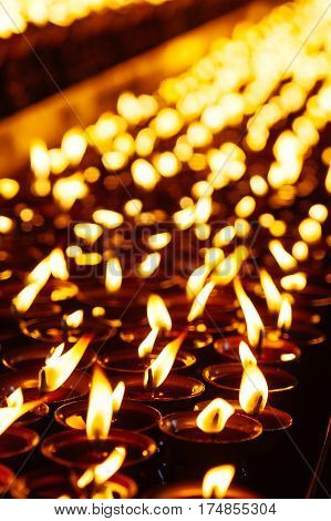 Many Candle Flames Glowing In The Dark