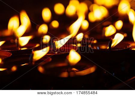 Many Candle Flames Glowing In The Dark