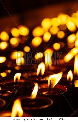Many Candle Flames Glowing In The Dark
