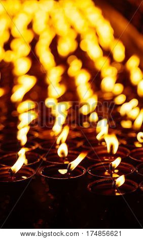 Many Candle Flames Glowing In The Dark