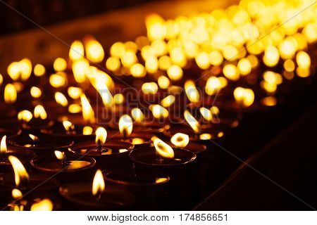 Many Candle Flames Glowing In The Dark