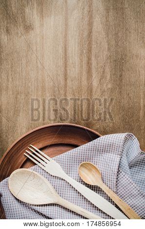 Rustic Kitchen Utensils: the Ceramic Plates and Wooden Cutlery on Wooden Background. Home Wares. Kitchen Decor in Rustic Style. View From Above With Copy Space.