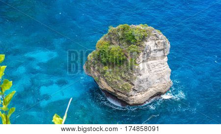 Lonely Rock in Sea Watter, North Coast, Nusa Penida - Bali, Indonesia.