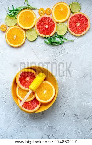 Homemade orange icecream with fresh fruits on stone table background top view mock-up