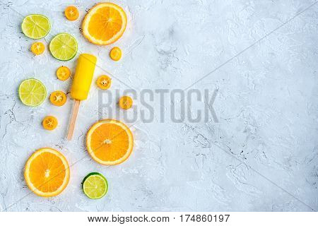 fresh citrus slices with fruit popsicles on stone table background top view mock up