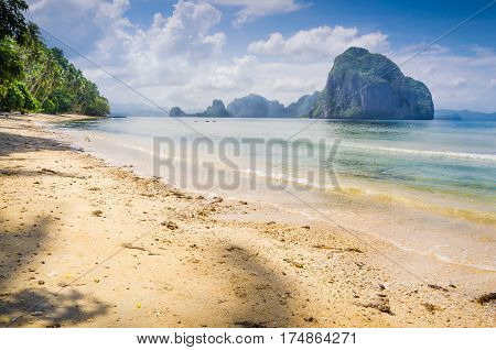 Landscape of El Nido. Sandy Beach with Huge Rock, Palawan island. Philippines.