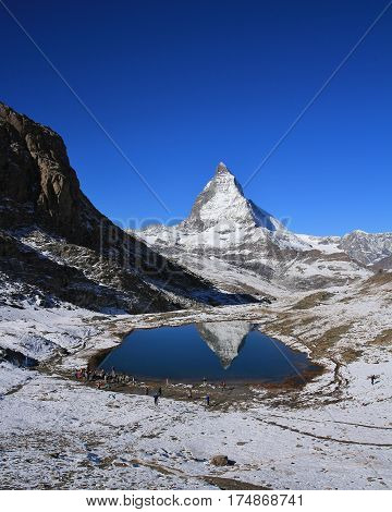 Matterhorn mirroring in lake Riffelsee. Autumn day in the Swiss Alps.