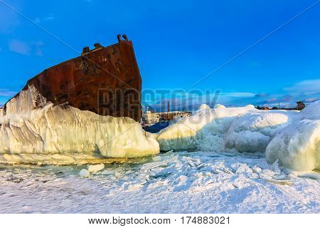 Old Rusty Ship On Ice Covered Sunset Standing On The Shore