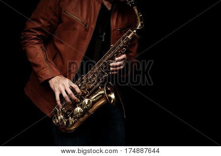 male jazz saxophone player on the stage with brown leather jacket