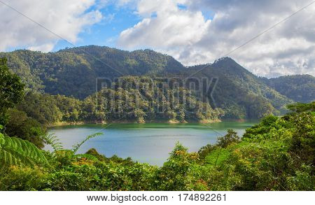 Natural landscape with lake and mountain. Outdoor travel on wild nature. Recreation zone with fresh air and water. lake in sunny day. Sunny landscape with green forest hills and lake.