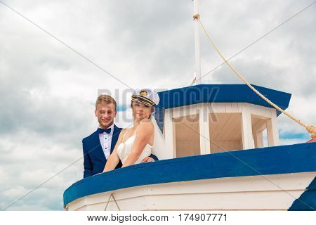 Wedding couple on small boat. The bride and groom on the ship.