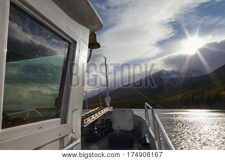 View from the ship front on sunset over mountains