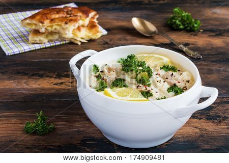 Avgolemono, Chicken Soup With Egg-lemon Sauce, Rice And Fresh Parsley Leaves In White Bowl And Fresh
