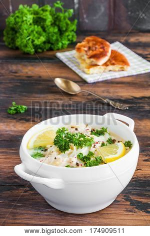 Avgolemono, Chicken Soup With Egg-lemon Sauce, Rice And Fresh Parsley Leaves In White Bowl And Fresh