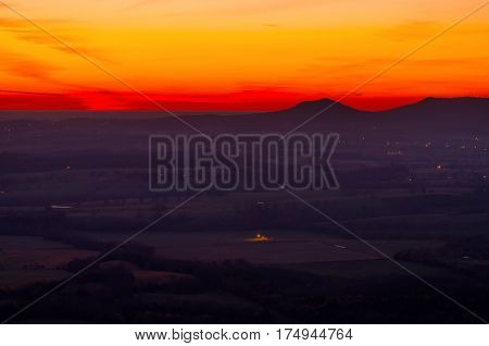 Predawn sunrise just outside of Harrison Arkansas. It is in the mountain overlooking the valley of farmland below. This is located in the Ozarks region of the state.