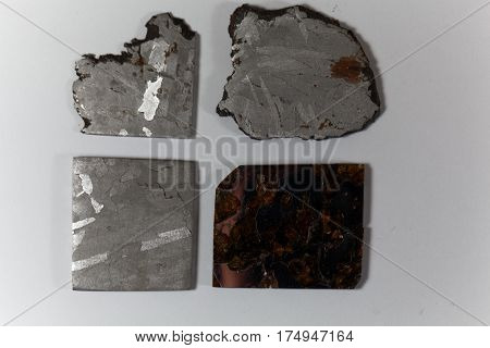 Iron meteorite pieces on a white background.