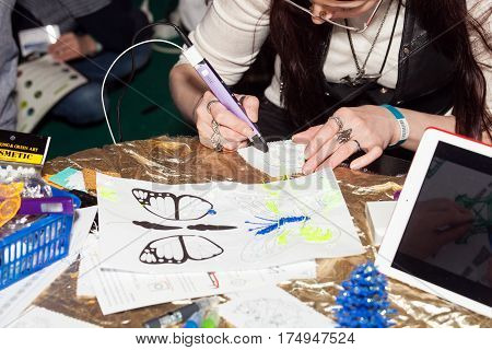 Moscow, Russia - November, 2016: Girl using 3D printing pen