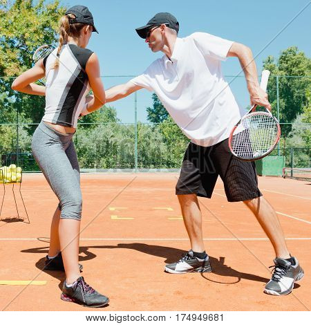 Tennis lessons - Tennis instructor working with student