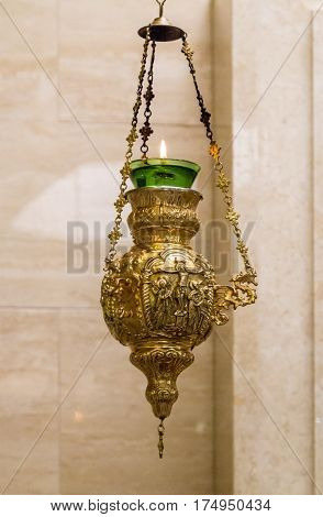 GALILEE ISRAEL - DECEMBER 3: Icon-lamp with lighted candle interior of the Sanctuary of the Word in Domus Galilaeae on the Mount of Beatitudes near the Sea of Galilee Israel on December 3 2016
