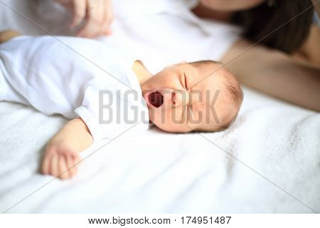 newborn baby sleeps next to mom .the photo has a empty space for your text