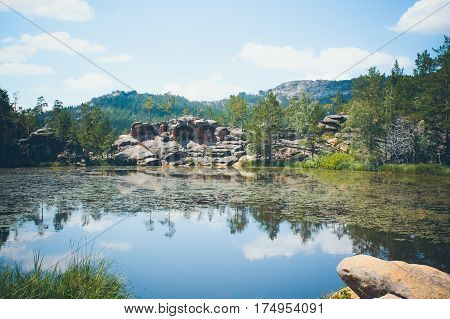 Mountain lake in the background of mountains and blye sky
