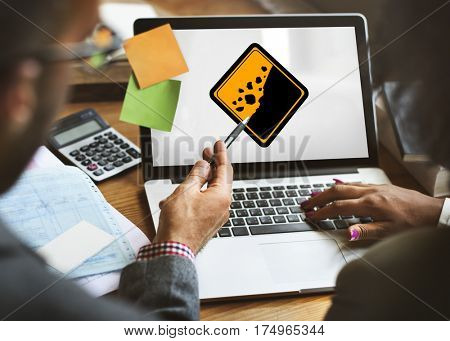 Business People Discussion Rockfall Beware Sign on Laptop