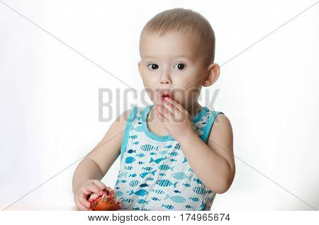 Baby eats a pomegranate ripe and juicy very tasty and joyfully