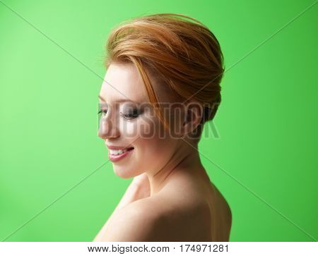 Young woman with trendy hairstyle on green background