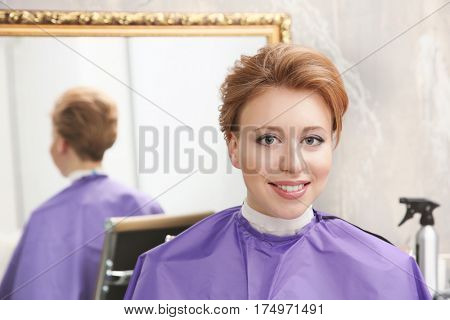 Young woman with trendy hairstyle at beauty salon