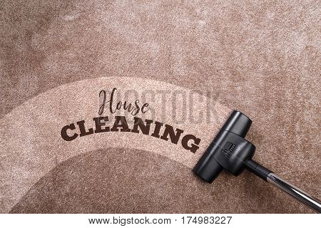 Vacuuming carpet with vacuum cleaner. House cleaning. Housework service. Close up of the head of a sweeper cleaning device.