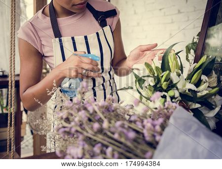 Woman Spraying Flowers to Refreshing in Flora Shop