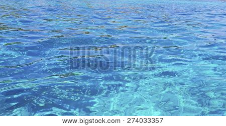 Clear Water Of Ocean. Background Of Water. Shining Blue Water. Over The Water.